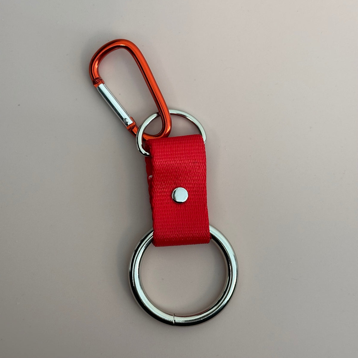 Red clip-on bandana holder with carabiner and metal ring